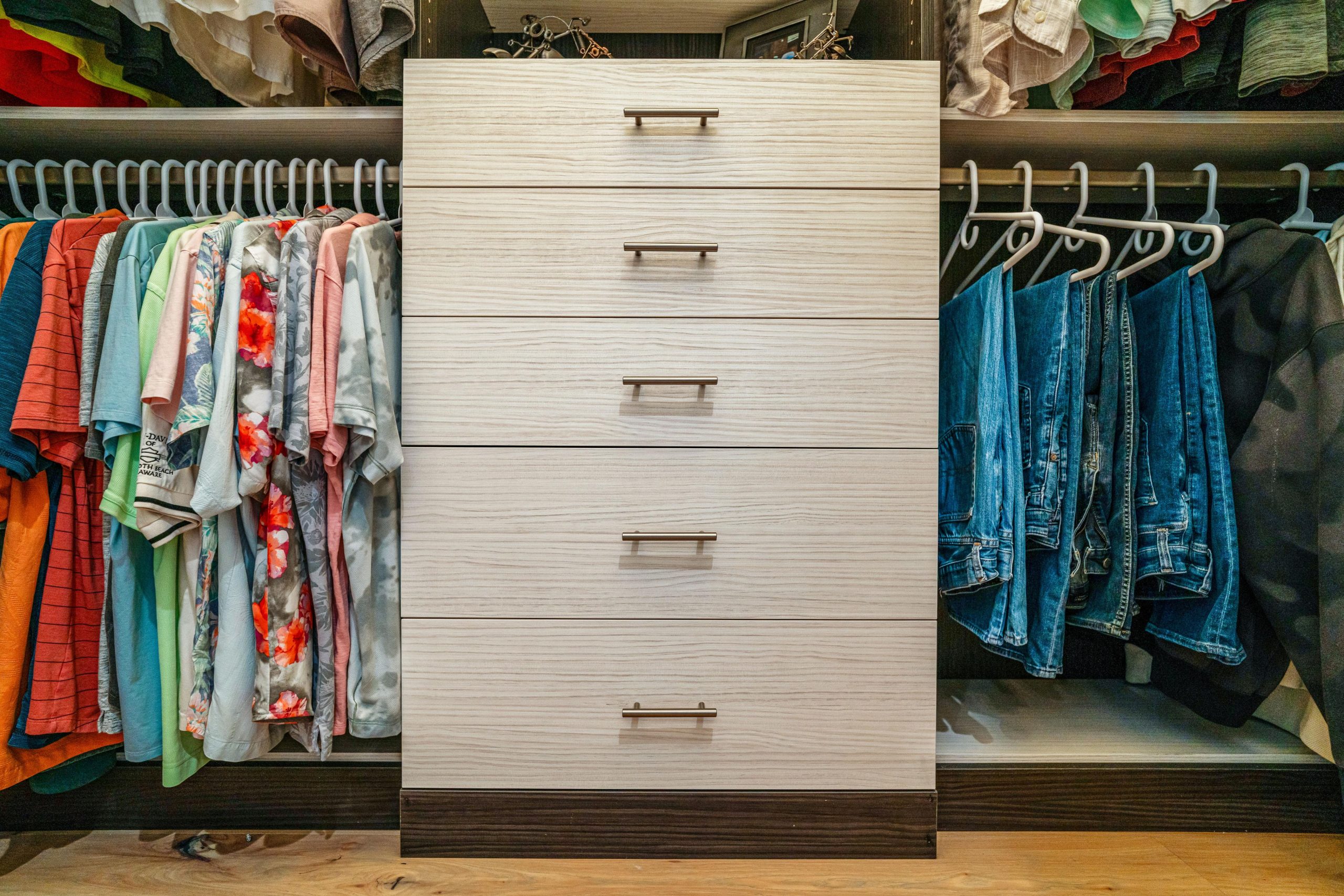 sarasota custom closet with cream-colored drawers next to closet rack